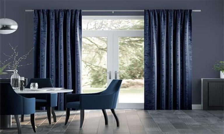 How do you create a cohesive look with Blackout curtains in a living area with multiple windows?